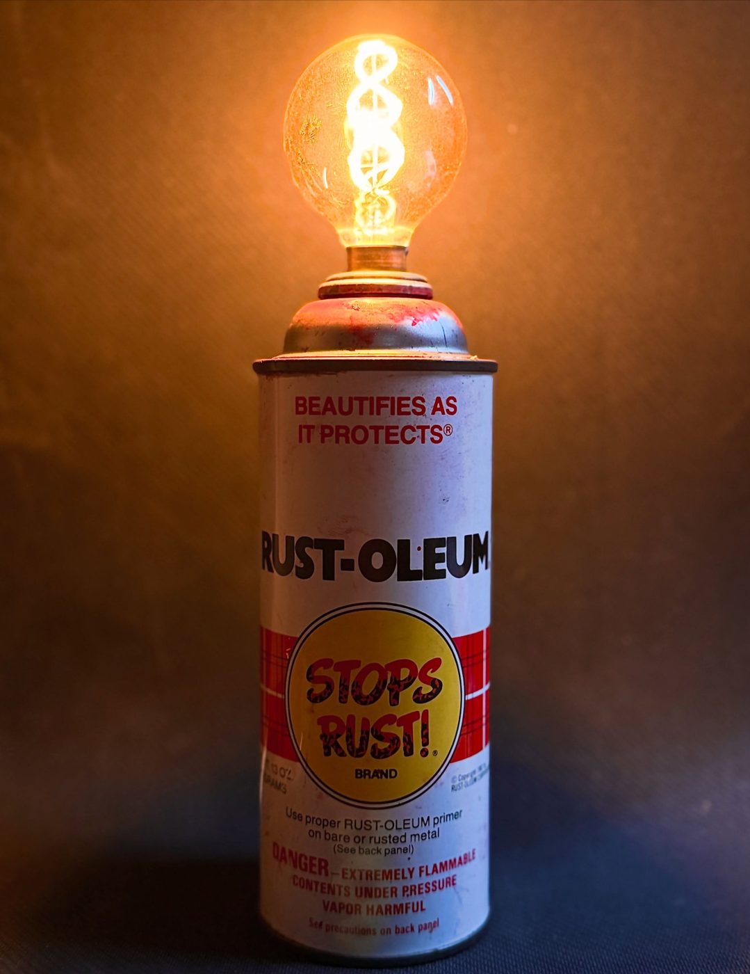 Vintage Rust-Oleum can made into a lamp with a swirling filament bulb