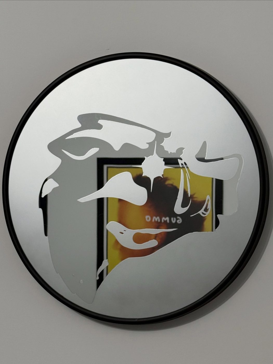 Round mirror with a hand-etched abstract graphic