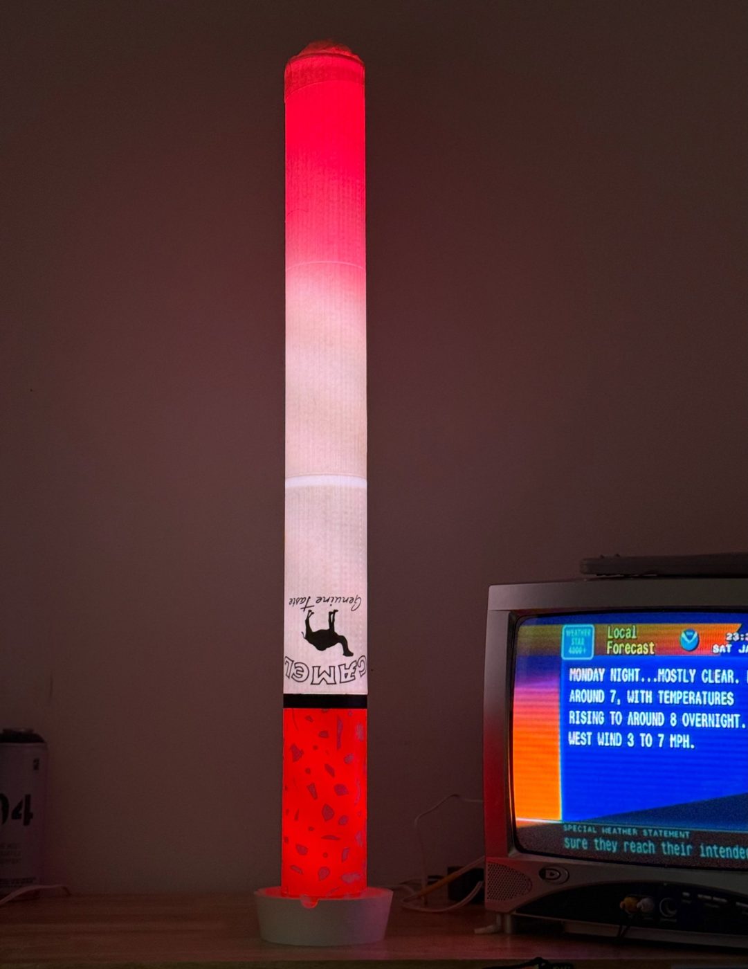 Giant glowing cigarette lamp standing in an ashtray base